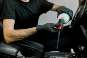 Fresno car owner checking questions to ask before hiring detailer for premium auto care.