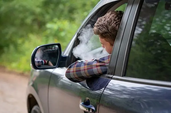 Expert guide on how to get smoke smell out of car permanently in Fresno, showing a clean car interior with fresh air.