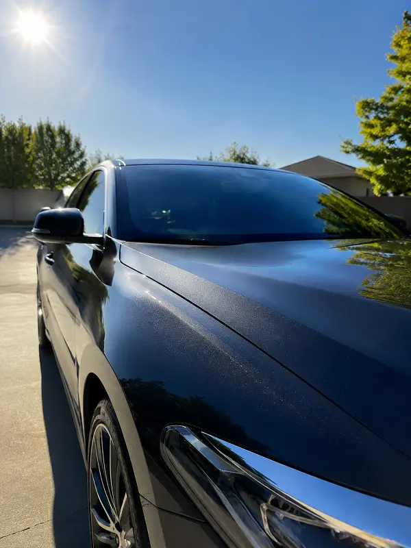 Ceramic coated car under strong Fresno summer sun showing glossy paint protection.