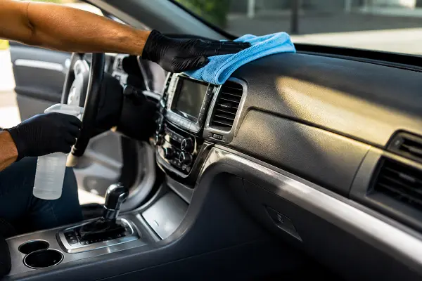 Interior surface protection applied to a car dashboard during detailing