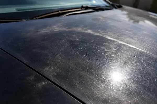 Swirl marks and dull paint showing signs a car needs exterior detailing.